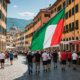 A flag waving in the wind at a sports event, symbolizing unity and community spirit in a picturesque Italian town.
