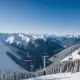 A snowy mountain landscape with ski lifts and a clear sky, indicating a return to normal winter conditions.