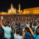 A lively concert scene with Coez performing on stage in Pisa, vibrant atmosphere, summer night, audience enjoying the mu